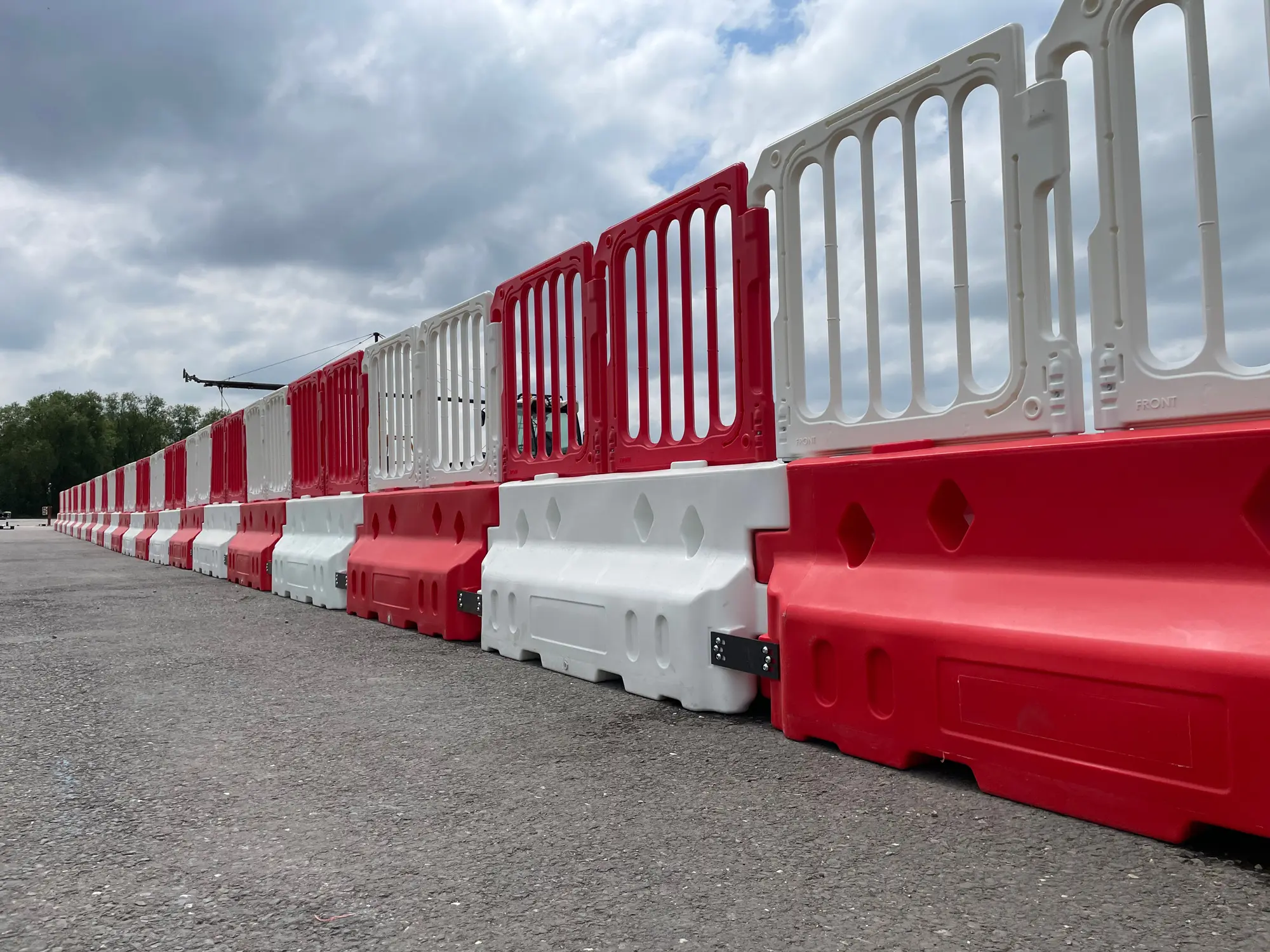 defender 50 crash barriers lined up connected with double top panel fencing