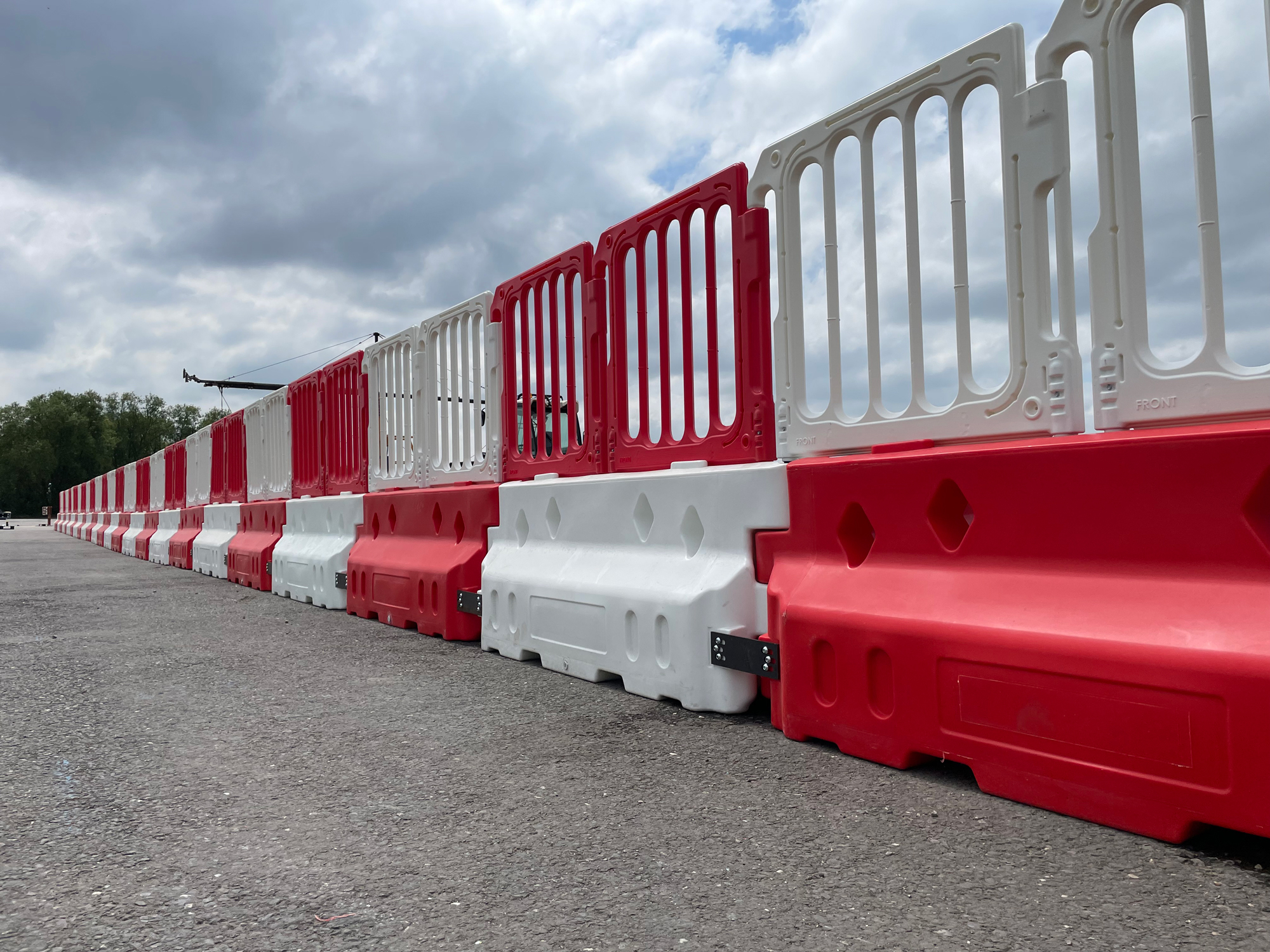 defender 50 crash barriers lined up connected with double top panel fencing