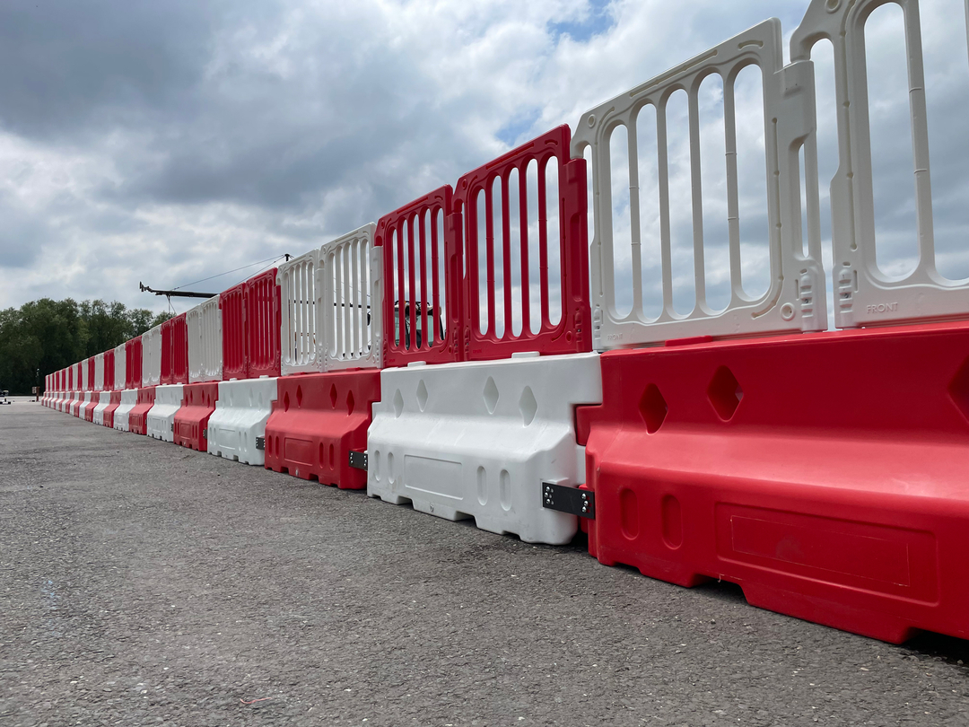 defender 50 crash barriers lined up connected with double top panel fencing