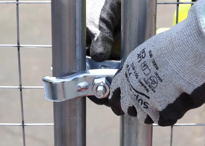 coupler being installed with worker on fencing to connect