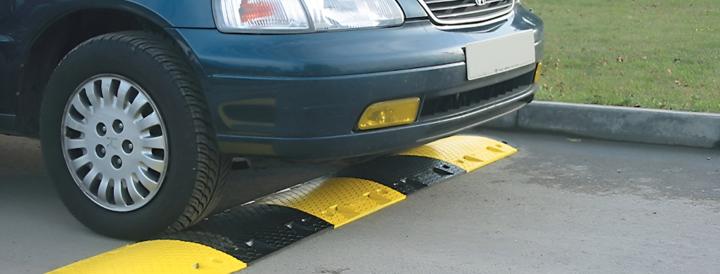 car driving over speed bump ramp