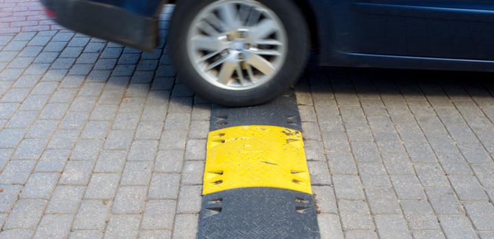 car driving over speed bump ramp