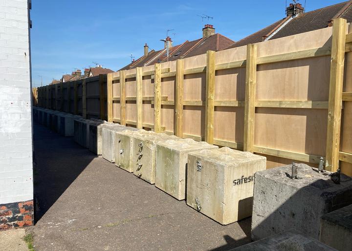 free-standing timber hoarding installed on public site with concrete lego blocks used as ballast