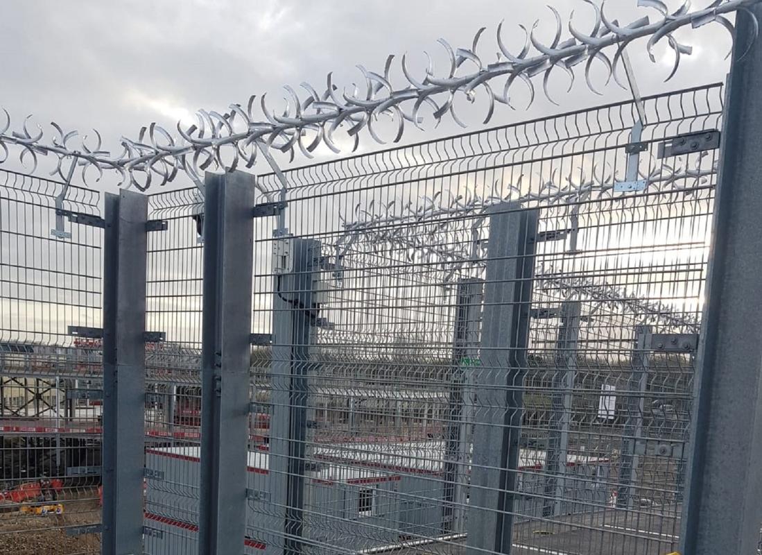 anti-climb spikes installed over high fence