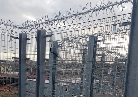 anti-climb spikes installed over high fence