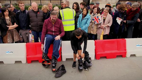 Stephen Fry sitting on Water Filled Barriers