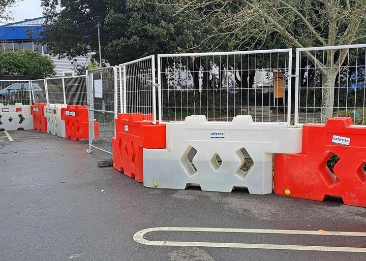 bison barriers attached at car park with mesh fencing