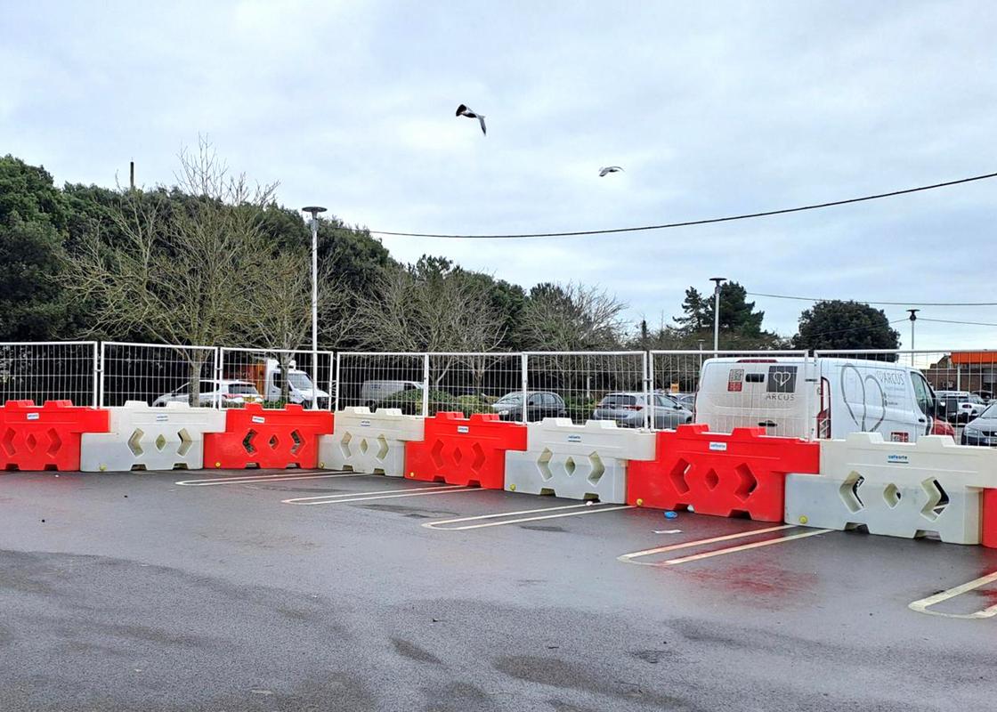 bison barriers attached at car park with mesh fencing