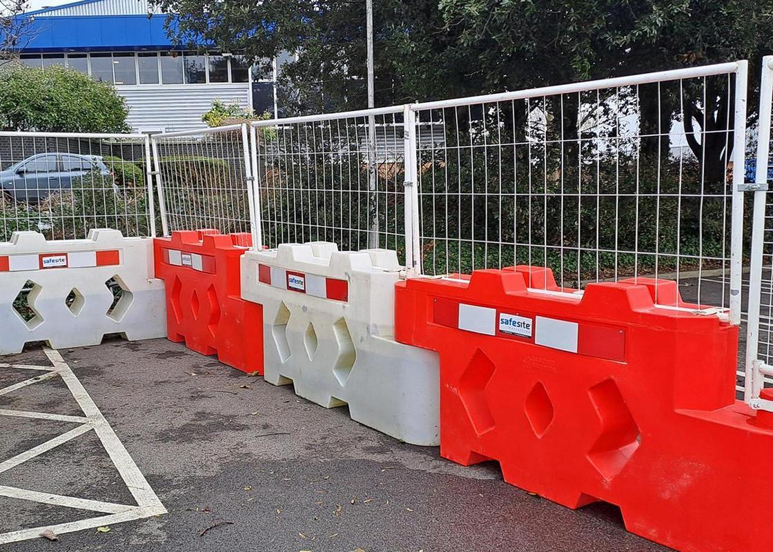 bison barriers attached at car park with mesh fencing