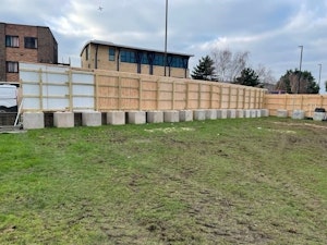 Free standing timber hoarding with concrete blocks