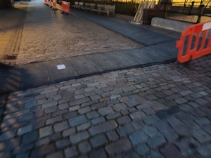 ground protection mats on cobbled surface