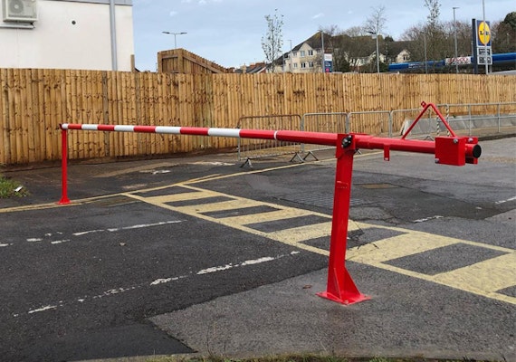 Manual Arm Barrier preventing unrestricted access to supermarket lorry bays