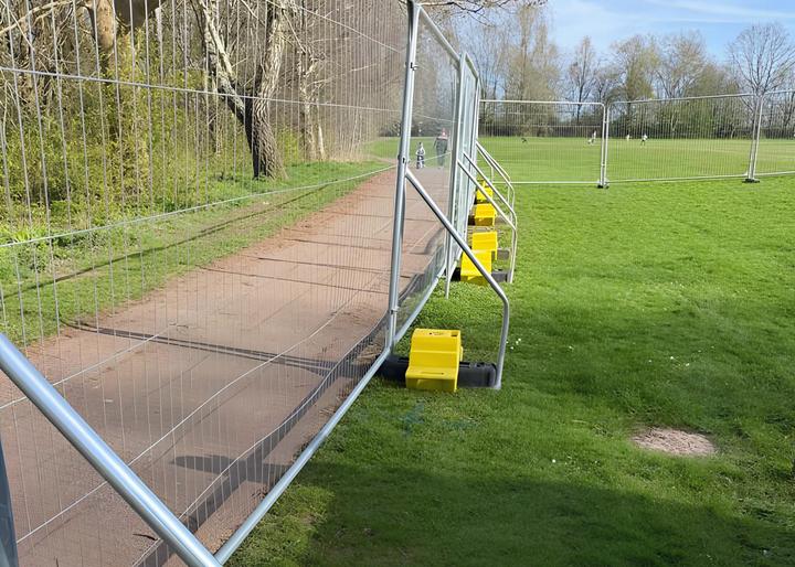 hi vis concrete ballast blocks being used on temporary fencing on field site