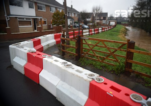 A line of flood barriers deployed in a housing estate adjoining the river