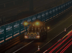 Acoustic barriers in action at night with a road vehicle