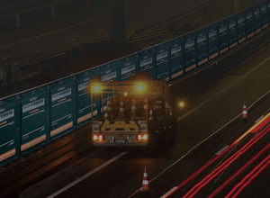 Acoustic barriers in action at night with a road vehicle