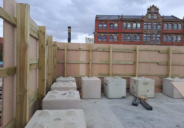 free standing timber hoarding supported by concrete legato blocks