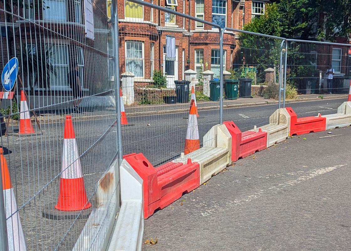 slotblock barriers installed with heras mesh fencing for pedestrian pathway on roadworks