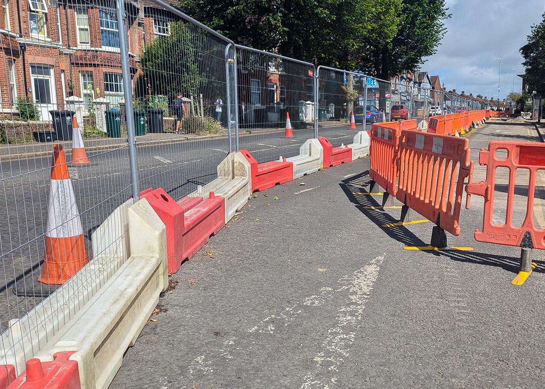 slotblock barriers installed with heras mesh fencing for pedestrian pathway on roadworks