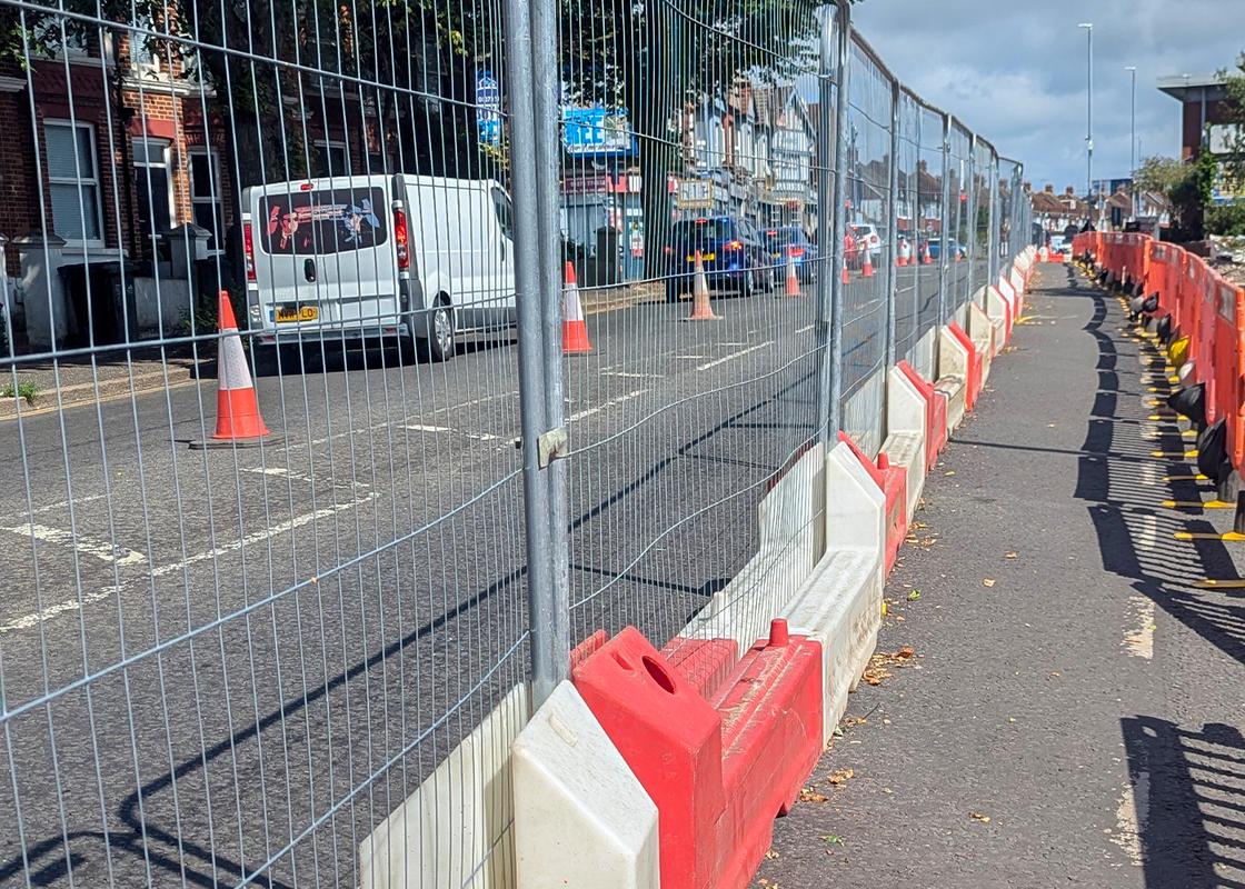 slotblock barriers installed with heras mesh fencing for pedestrian pathway on roadworks