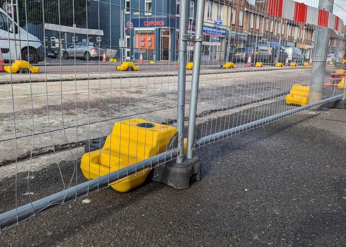 stepped ballast block with fencing in public street-works
