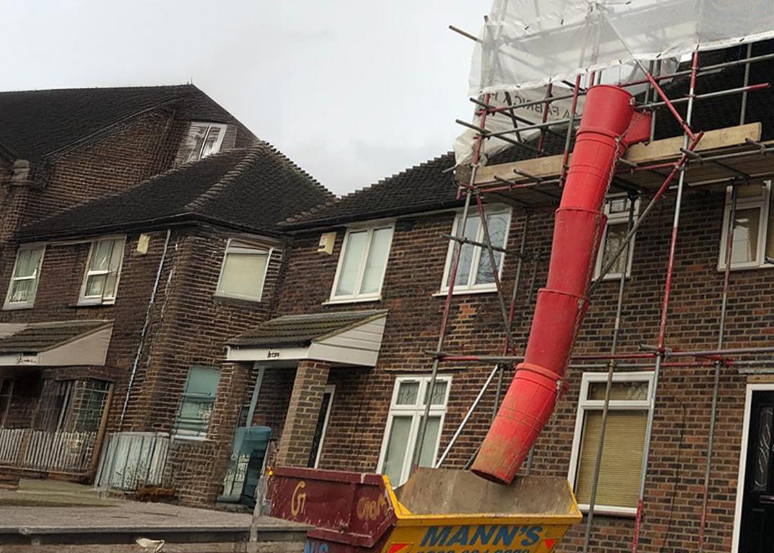 20 inch rubbish chutes attached showing debris landing in skip
