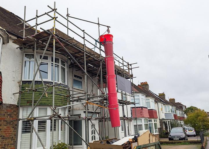 20 inch rubbish chutes attached showing debris landing in skip
