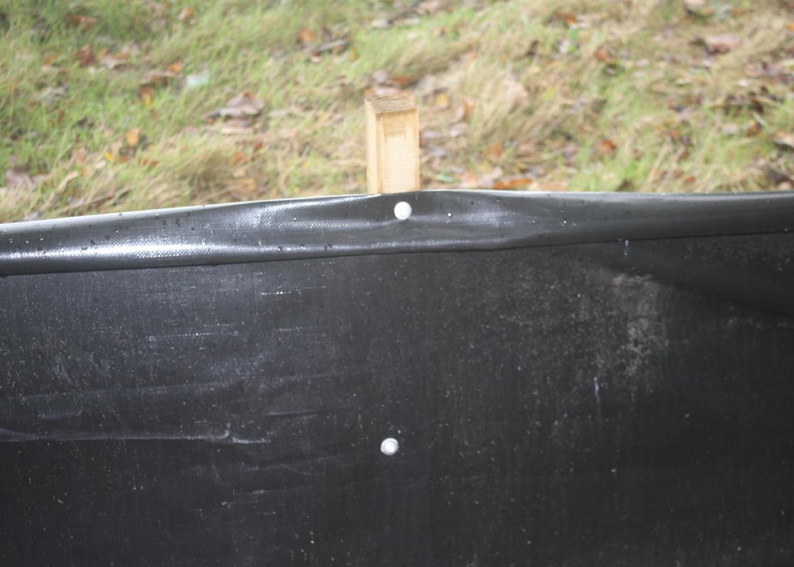 heavy-duty semi permanent newt fencing attached to timber post