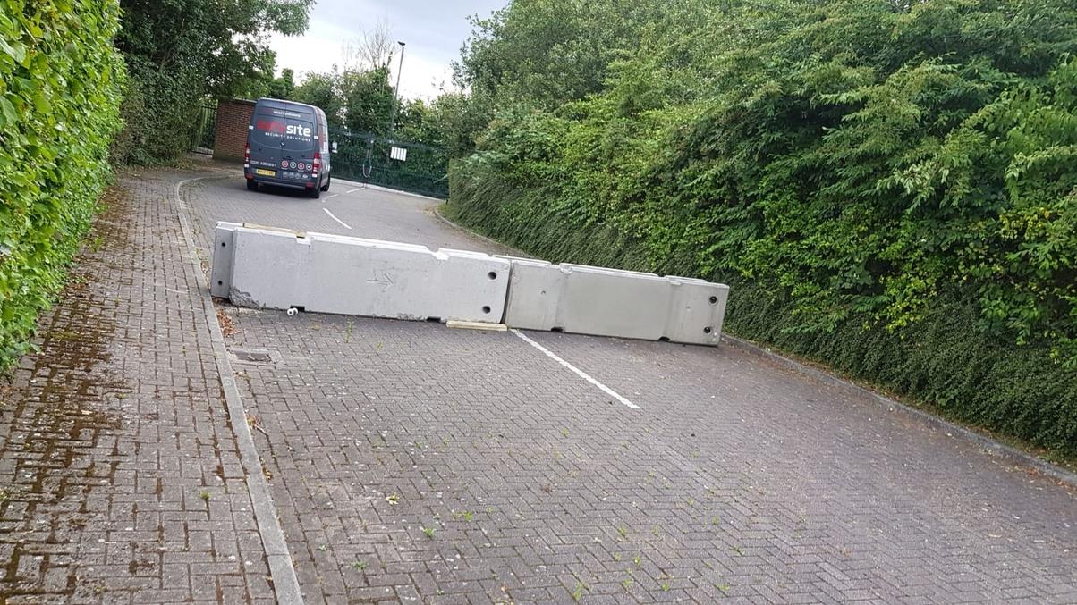 concrete blocks with a van in distance