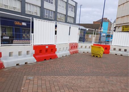 GB2 Barriers connected in highstreet with fencing and hoarding