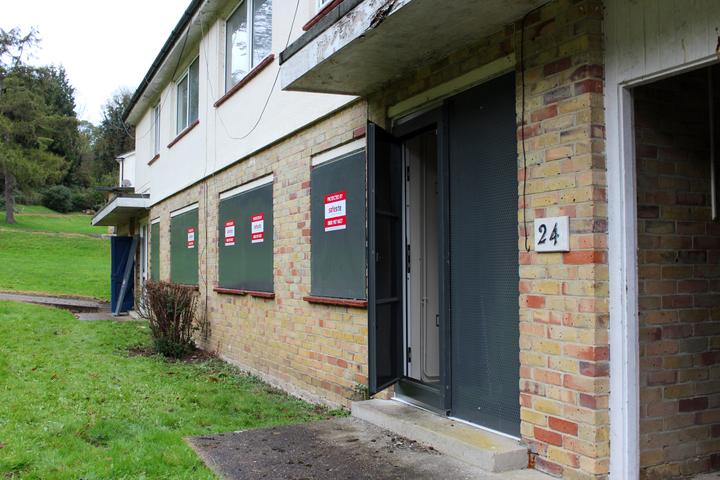 steel security sitex screens installed on window areas of vacant property and steel security doors installed