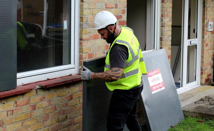 sitex steel screens beginning to be installed on vacant property window area