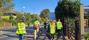 People in high vis jackets liter picking on the streets