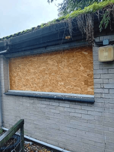 timber boarding on covering window on vacant property