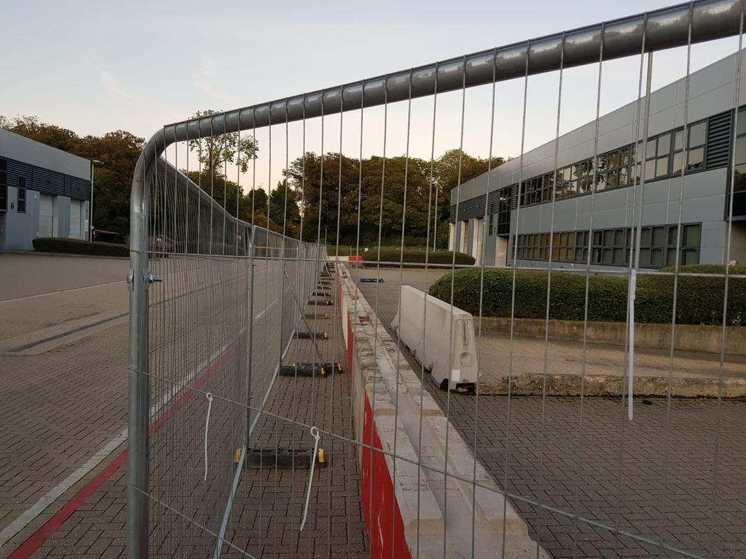 a long row of concrete blocks and fencing in front