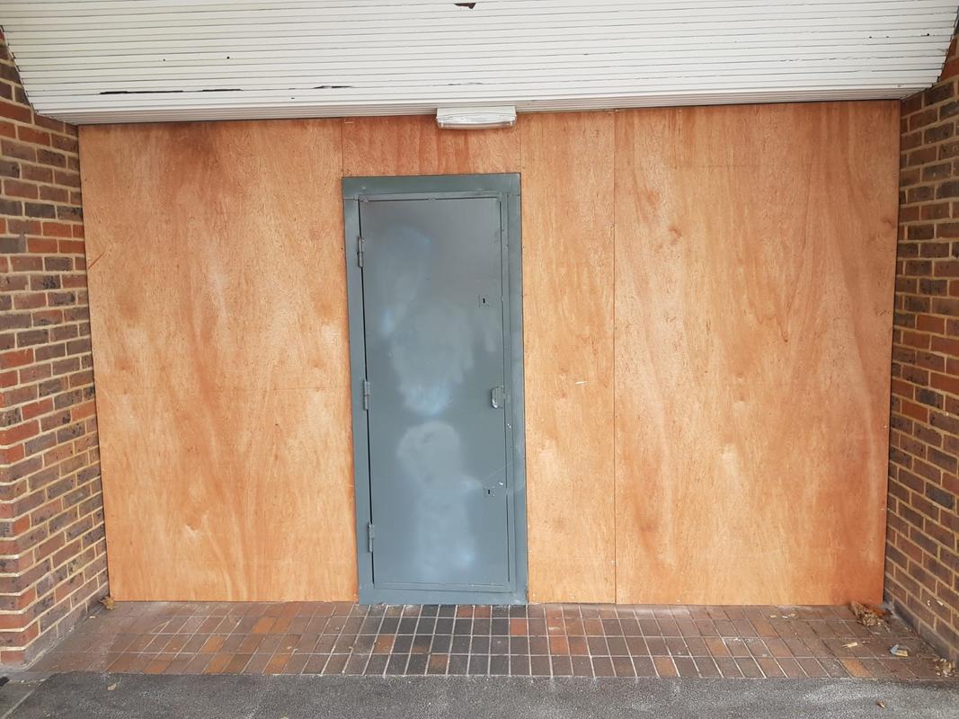 timber boarding up steel door
