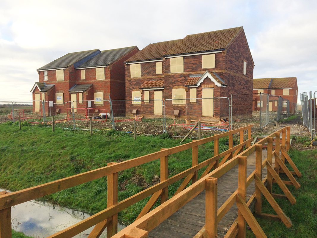 A vacant property with boarded up windows and entry points
