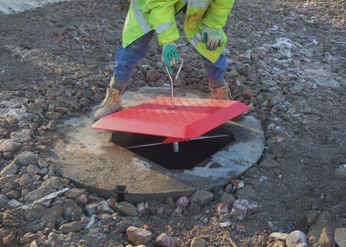 Man installing the Temporary Manhole Cover
