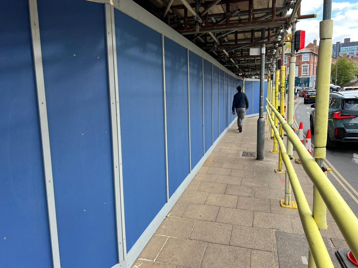 timber hoarding attached to scaffolding