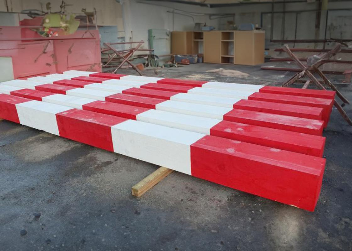 red and white baulk timber in line at warehouse