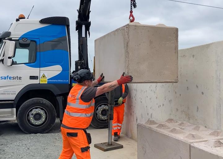 legato concrete barrier installation with forklift manoeuvring the concrete barriers