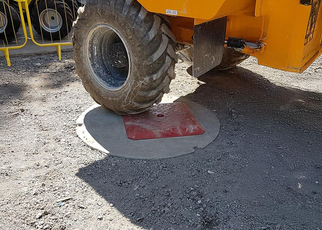 heavy plant vehicle driving over a Temporary Manhole Cover