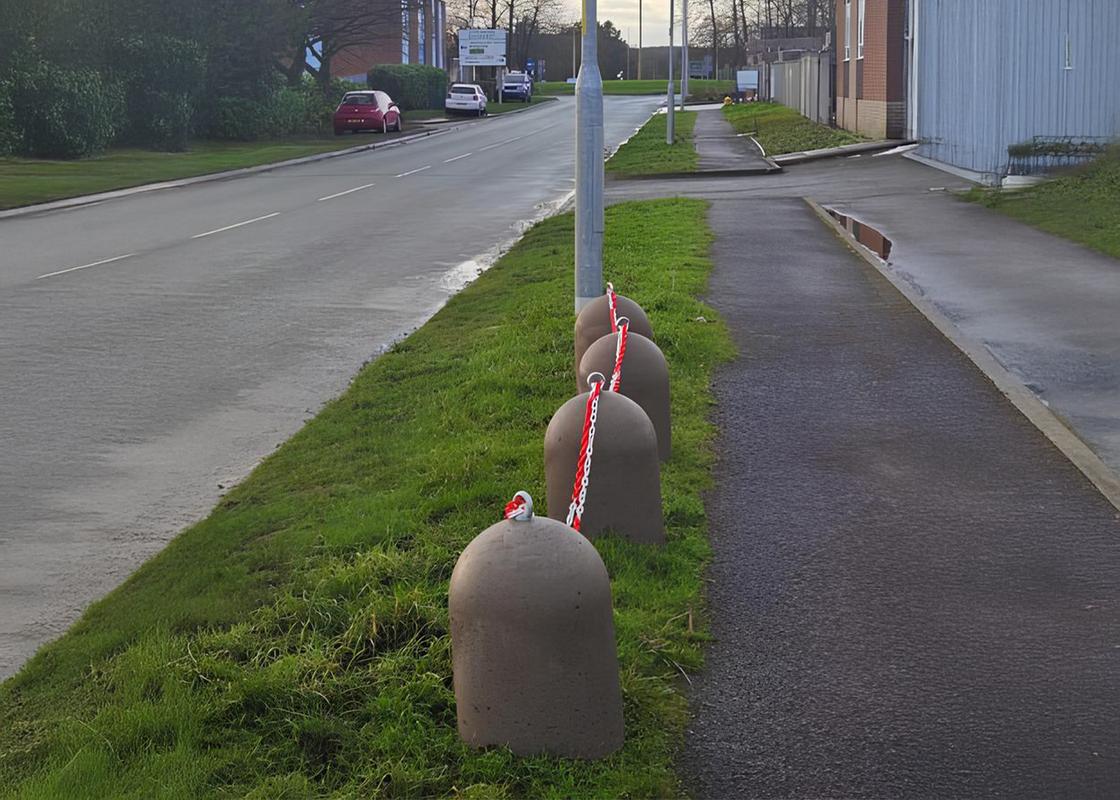 concrete stub bollard in situ with barrier chains connecting bollards
