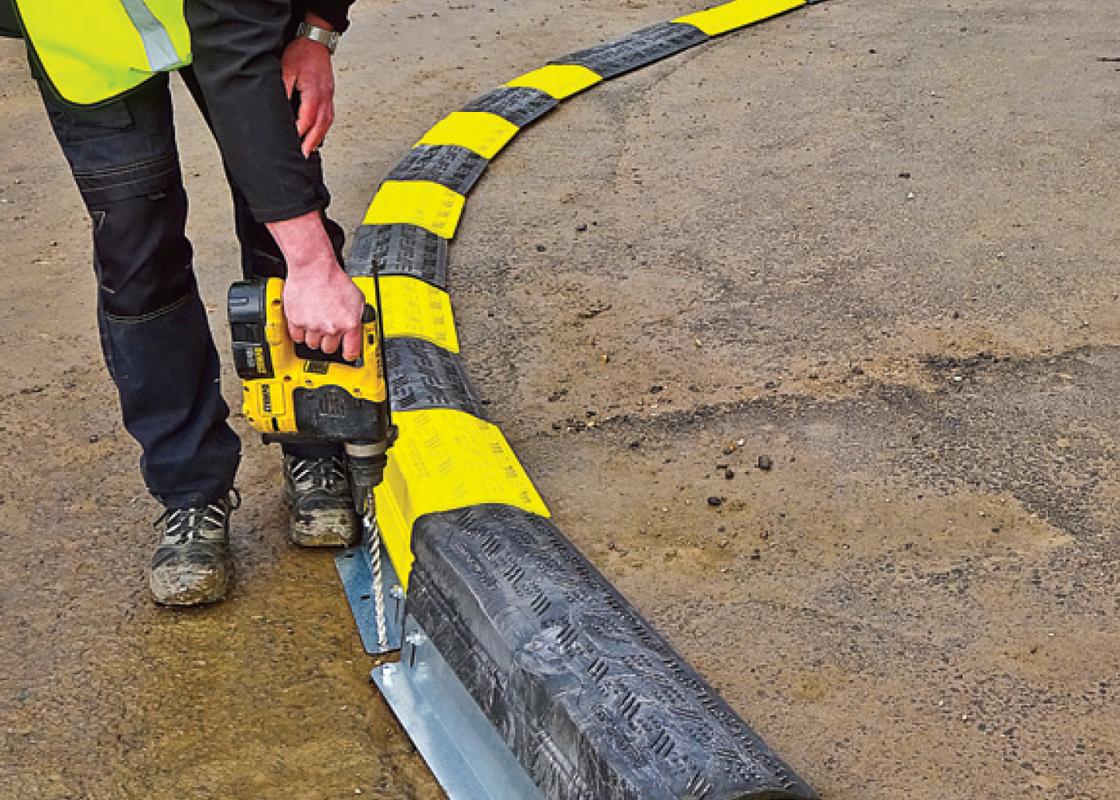 Heavy Duty Kerb Guard Temporary Protection being bolted to the ground