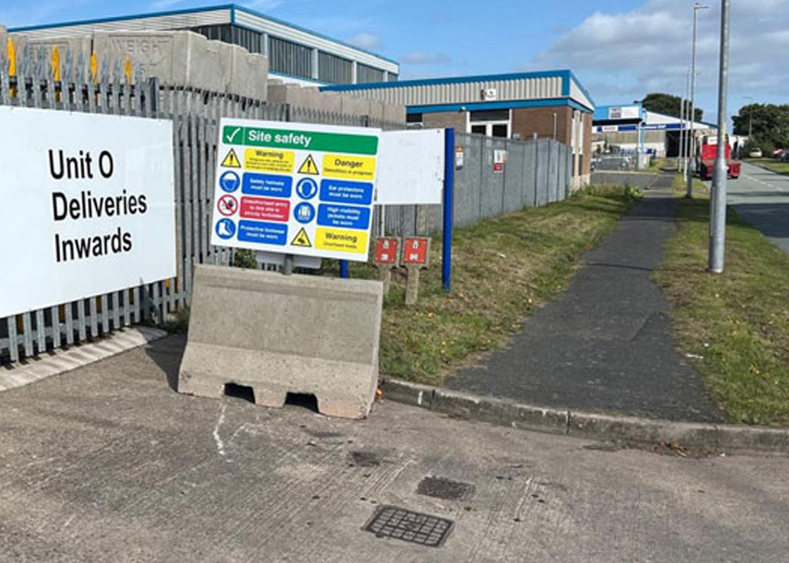 1.2m concrete jersey barrier with signage attached